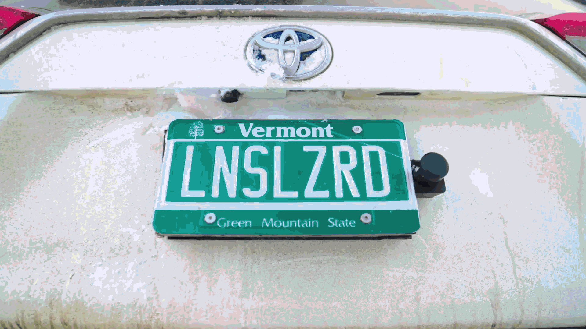 The Lens Lizard squirts cleaner at a backup cam