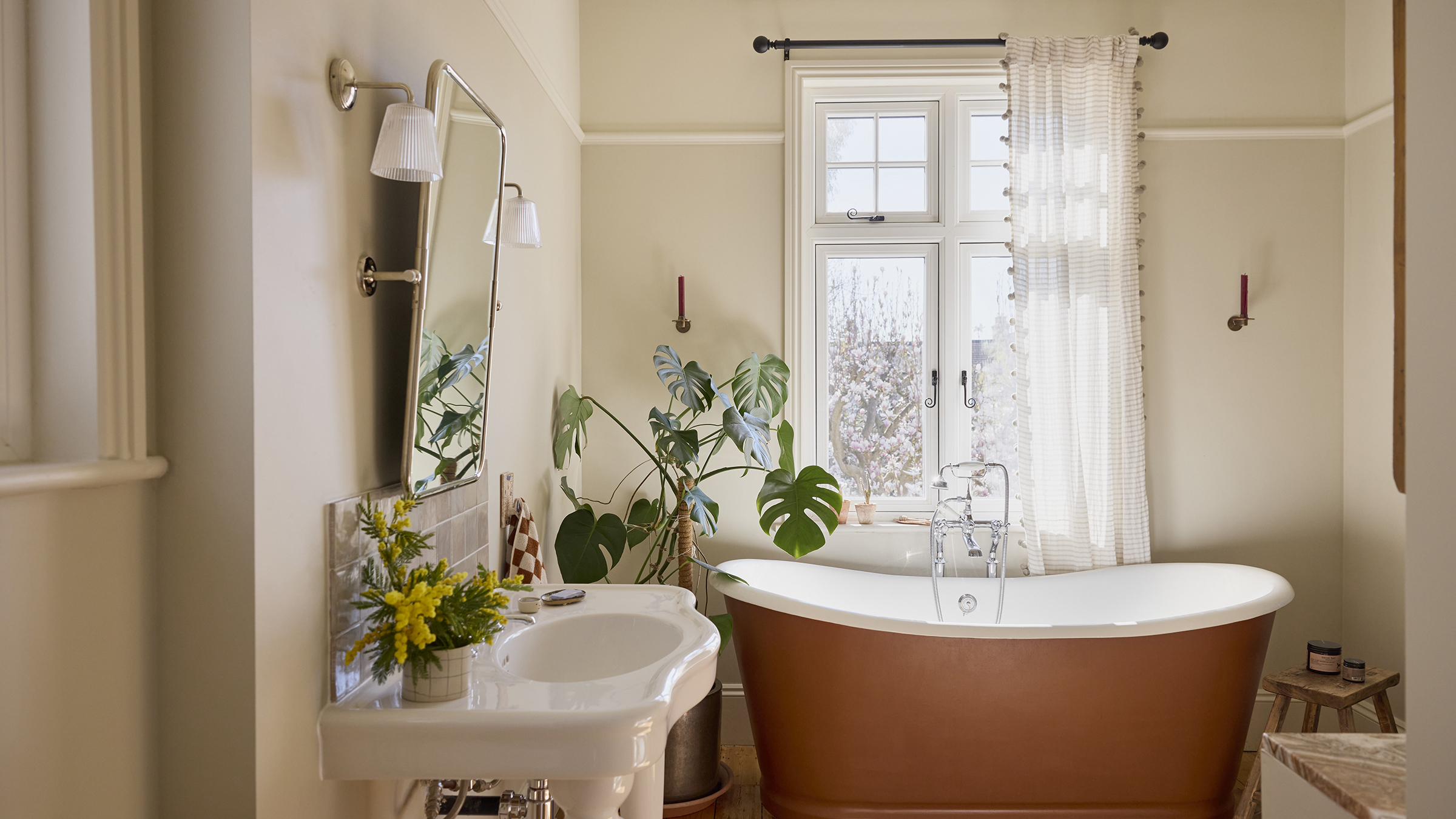Bathroom with terracotta bath and big plant