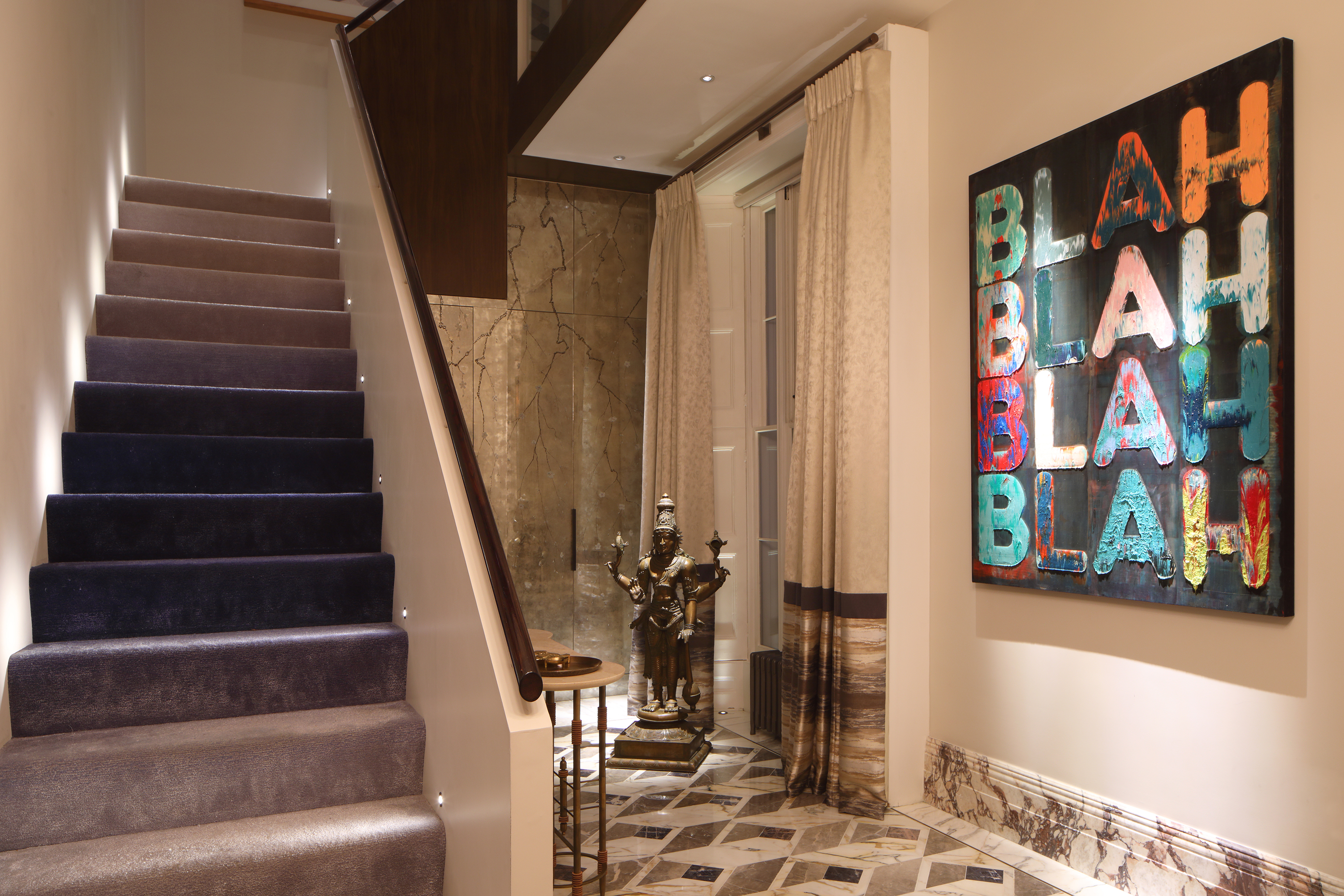 Interior with graphic artwork featuring lighting design by John Cullen Lighting