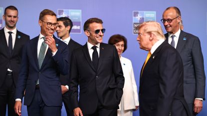 President Donald Trump joins President of Finland, Alexander Stubb, French President, Emmanuel Macron and German Chancellor, Friedrich Merz ahead of a family photo during the NATO summit in Turkey