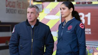 Hermann and Kidd standing next to each other in front of the firetruck on Chicago Fire.