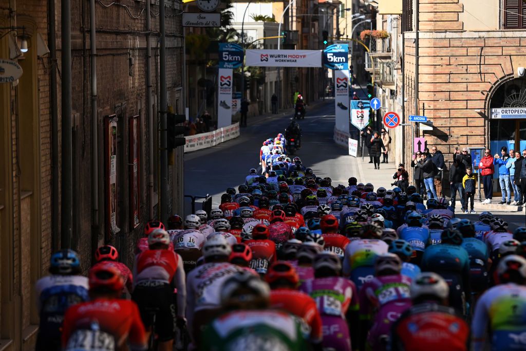 SAN BENEDETTO DEL TRONTO ITALY MARCH 13 A general view of the peloton passing through the streets of San Benedetto del Tronto while fans cheer during the 57th TirrenoAdriatico 2022 Stage 7 a 159km stage from San Benedetto del Tronto to San Benedetto del Tronto TirrenoAdriatico WorldTour on March 13 2022 in San Benedetto del Tronto Italy Photo by Tim de WaeleGetty Images