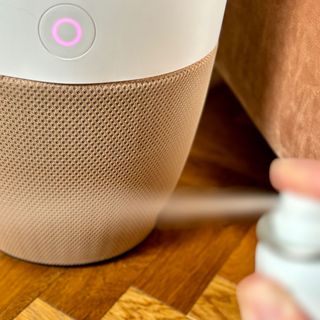 spraying deodorant near the dupray bloom air purifier