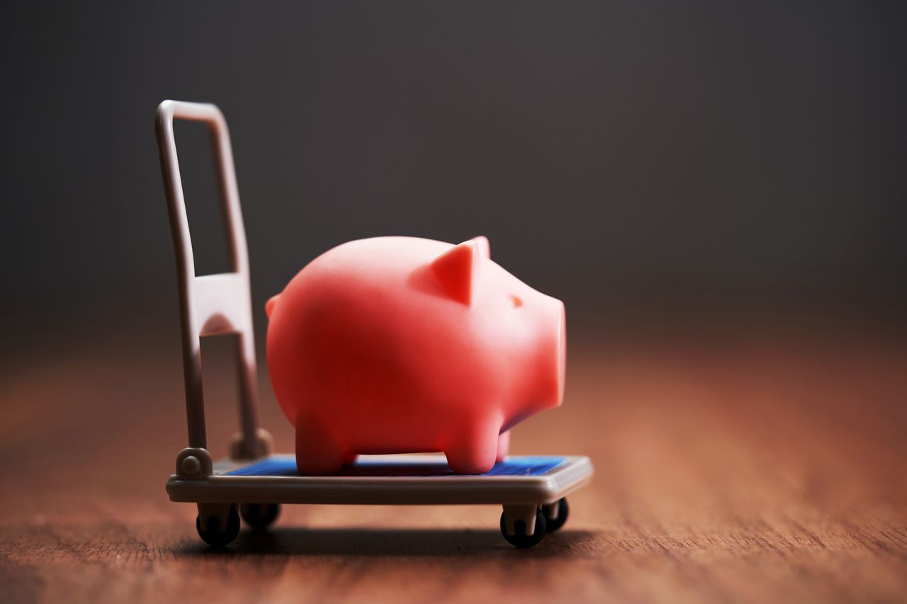 Hand Truck Carrying Piggy Bank