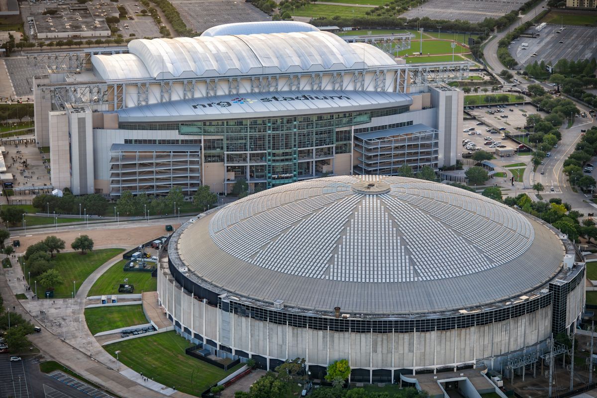 Houston, United States - April 13, 2023: Aerial view of both the NRG Stadium, home to the NFL&amp;apos;s Houston Texans, and the historic Astrodome, the first indoor sports arena, now listed as a historic site shot via helicopter from an altitude of about 600 feet