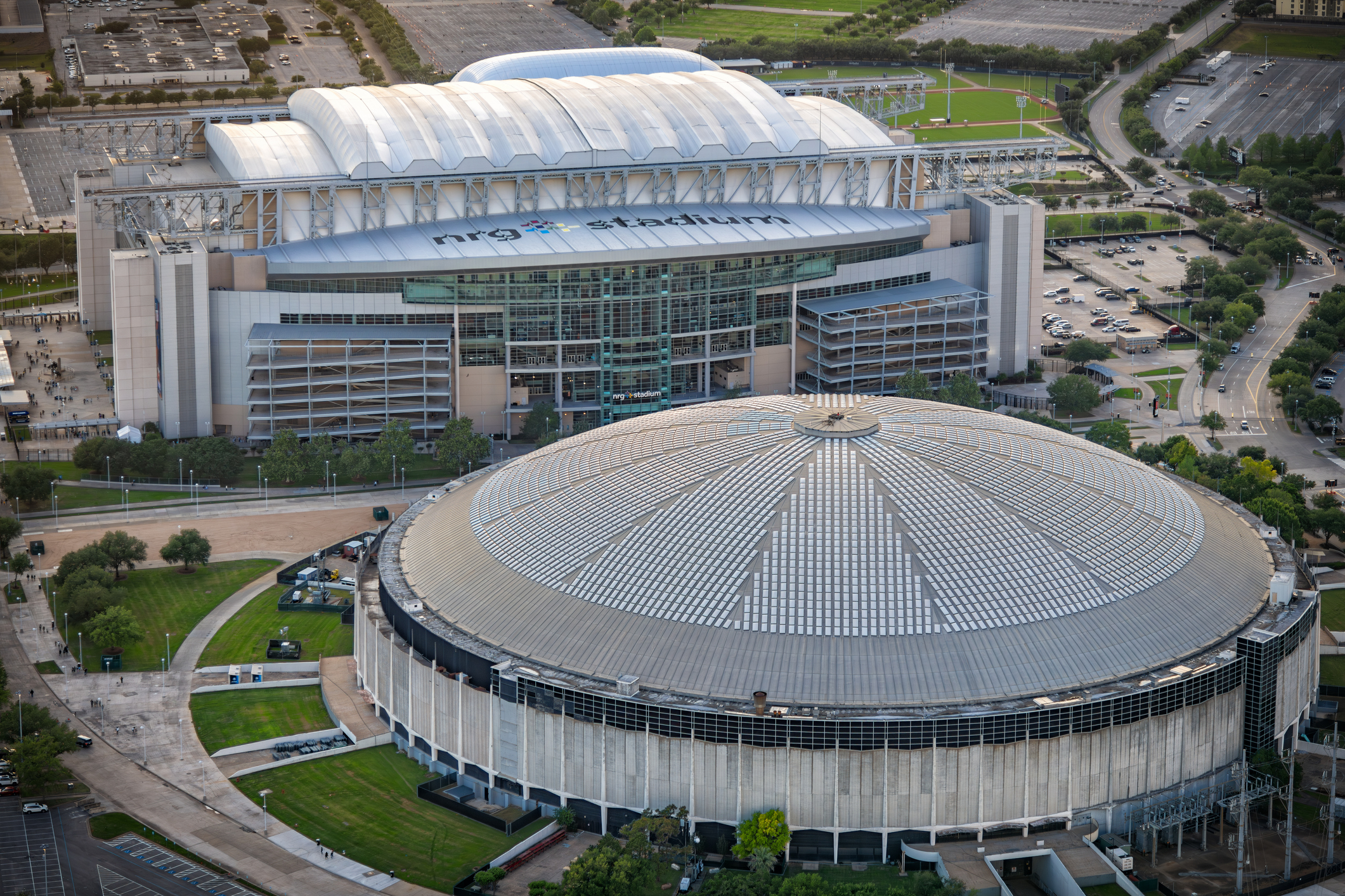 Houston, United States - April 13, 2023:  Aerial view of both the NRG Stadium, home to the NFL's Houston Texans, and the historic Astrodome, the first indoor sports arena, now listed as a historic site shot via helicopter from an altitude of about 600 feet