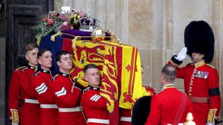 The coffin of Queen Elizabeth II with the Imperial State Crown resting on top is carried by the Bearer Party as it departs Westminster Abbey during the State Funeral of Queen Elizabeth II