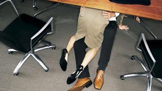 man and woman making out between shelves of files