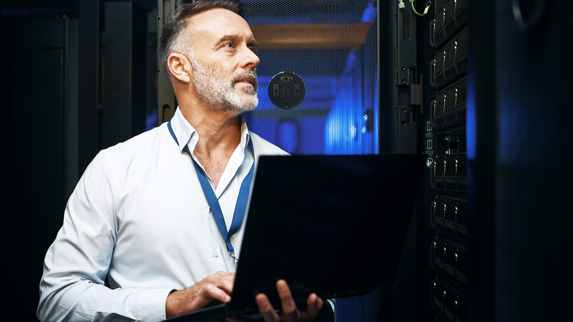 Person using a laptop in a data center