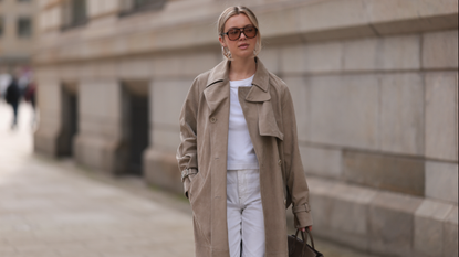  Isabelle Hartmann seen wearing Corlin Eyewear brown sunglasses, COS white cotton basic t-shirt, Max Mara beige suede leather oversized trenchcoat / long coat, Levi’s white vintage denim straight leg pants / jeans and Hermès Birkin 25 brown / taupe leather handbag on April 05, 2024 in Hamburg, Germany.