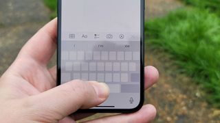 iPhone 13 with keyboard trackpad showing