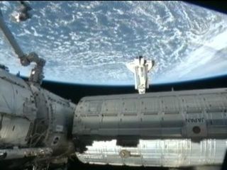 Shuttle Astronauts Make Midnight Docking at Space Station