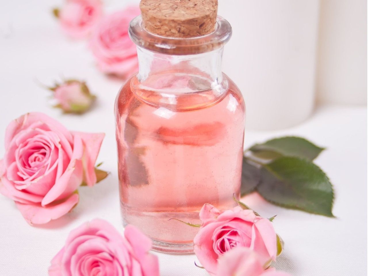 Pink Roses Next To Rose Water