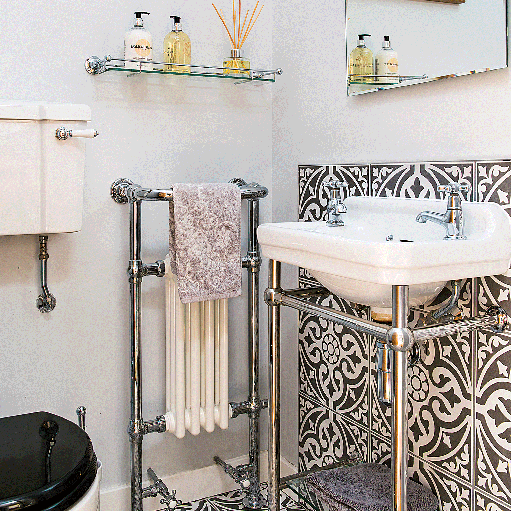 Black and white tiled spashback in cloakroom
