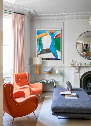 Modern living room with orange chairs