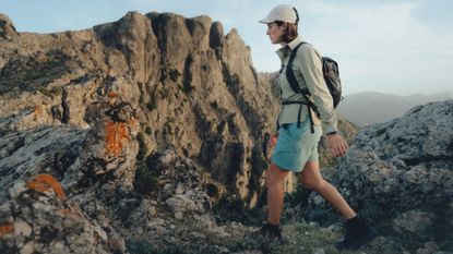 Best women's walking shoes: Young woman walking in the mountains
