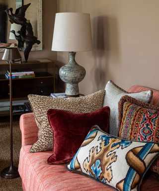 cozy taupe living room corner with a pink couch and two lamps