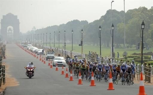 Cyclists ride along Rajpath in front of India Gate in New Delhi.