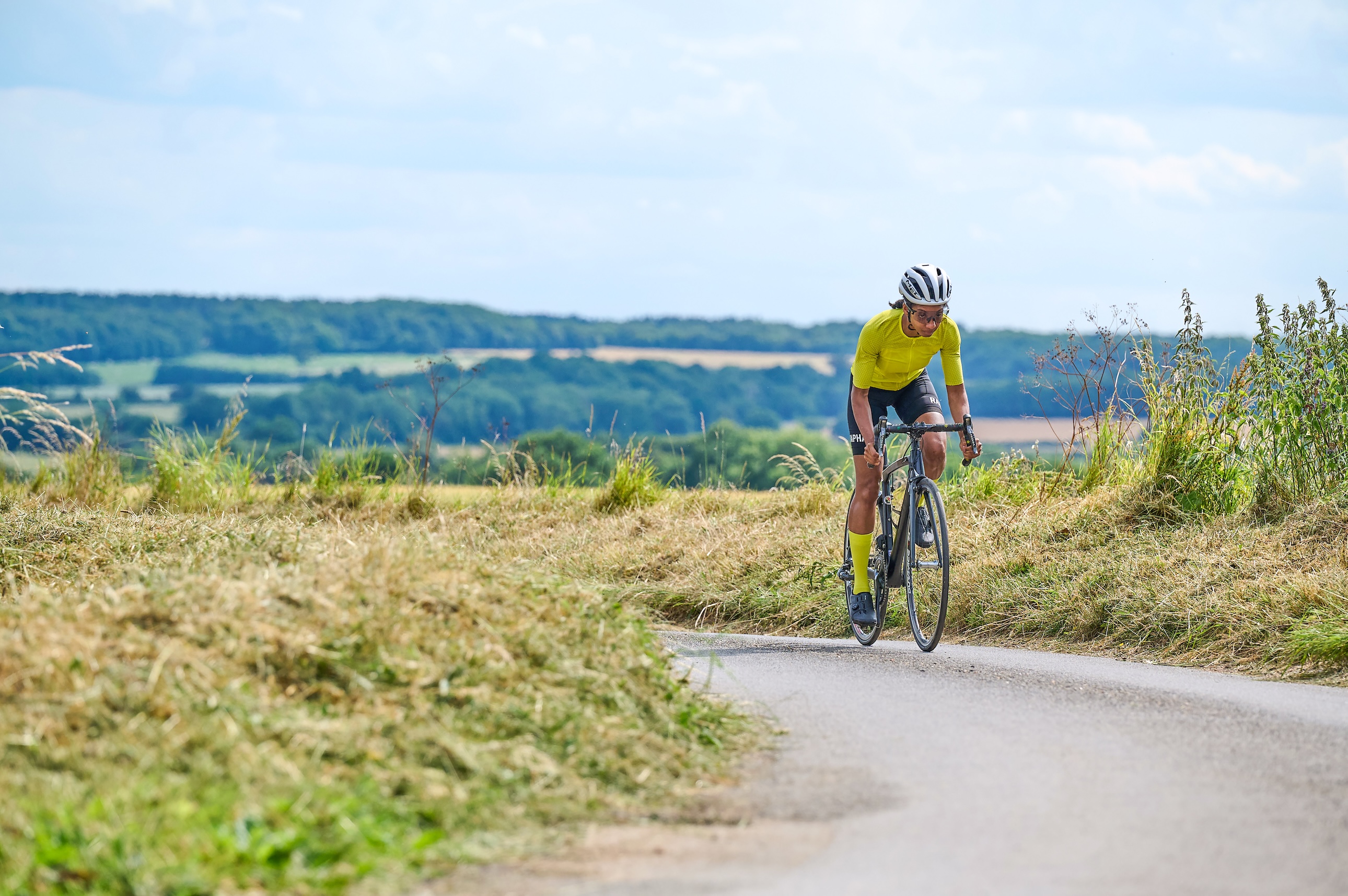 Female rider in yellow jersey riding in the countryside
