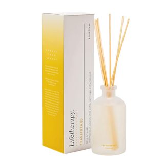 A Lifetherapy reed diffuser next to a yellow and white box