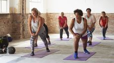 Women learning how to get fit in exercise class