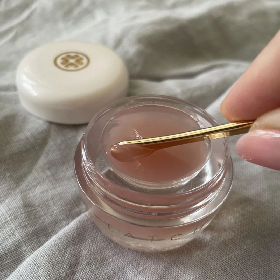 a hand scooping product out of one of the best lip masks from the article 