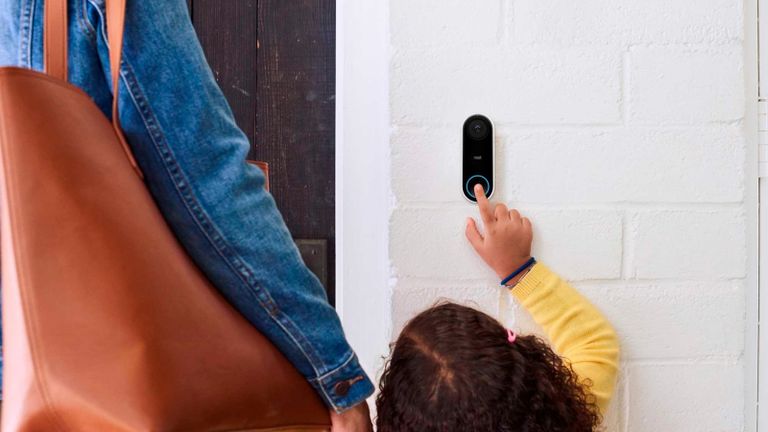 best smart doorbell: Google Nest Hello being pressed by young girl wearing yellow