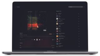 Tidal's playback and queue interface displayed on a Mac Pro laptop