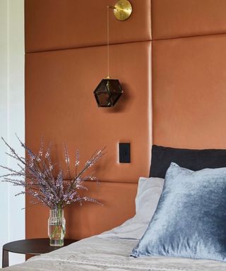 Bedroom with orange headboard