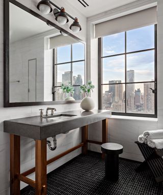 Trevor Noah's Penthouse – Bathroom with stone sink vanity, window with city views