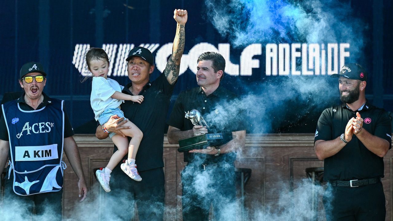 Anthony Kim holding his daughter and celebrating on the LIV Golf podium in Adelaide