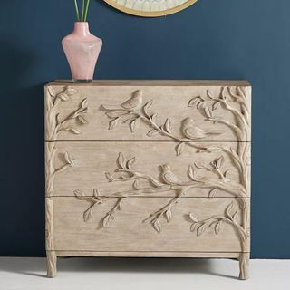 Anthropologie Ornithology Dresser against a navy wall.