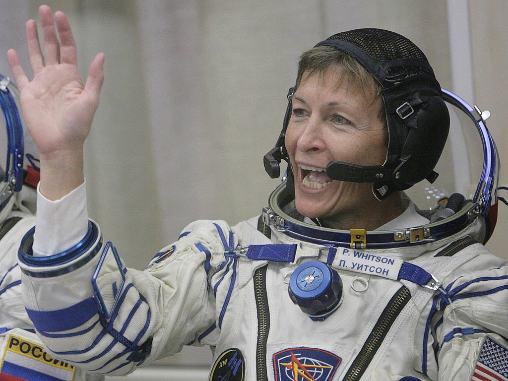 Peggy Whitson waves in her spacesuit.