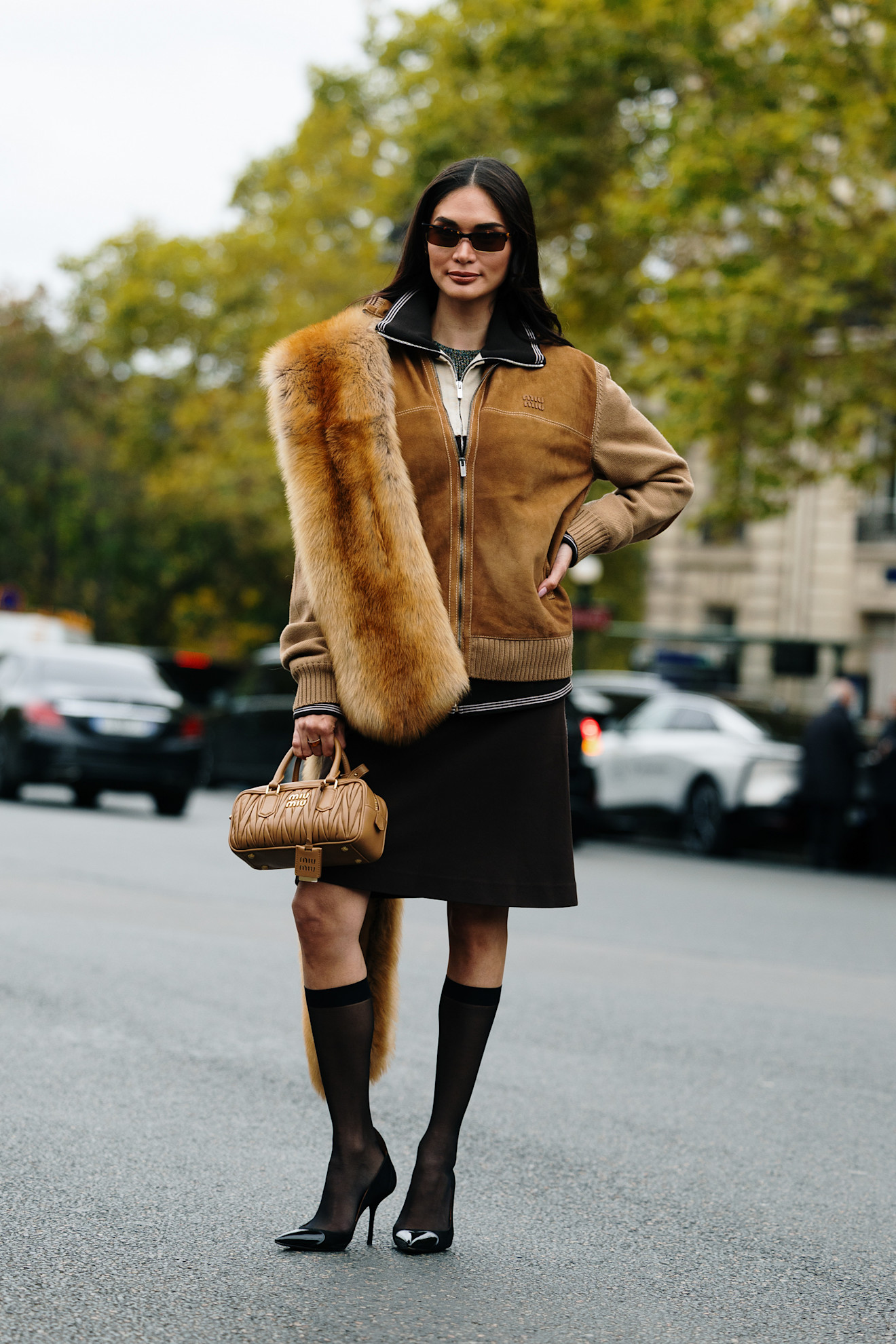 Fur accessory trend is shown in a street style photo of a woman