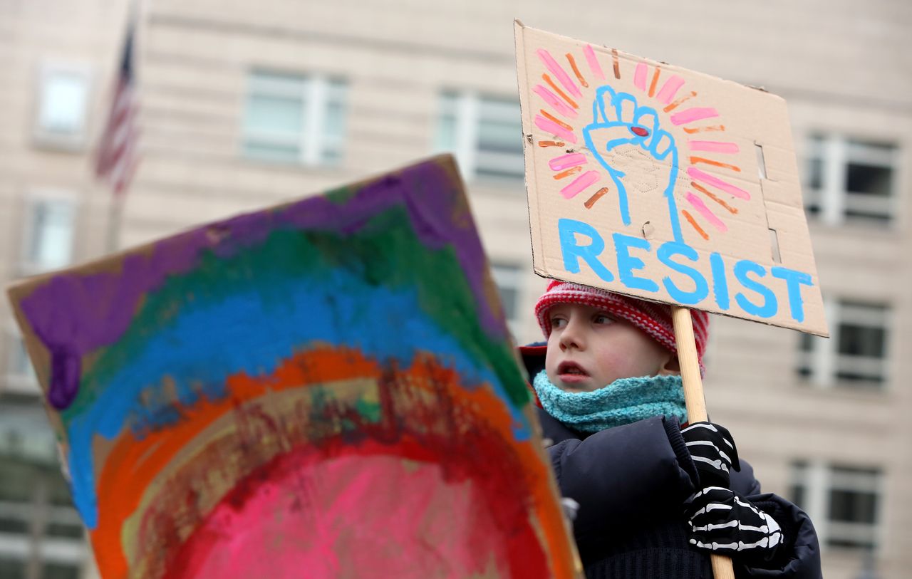 A child with a protest sign. 