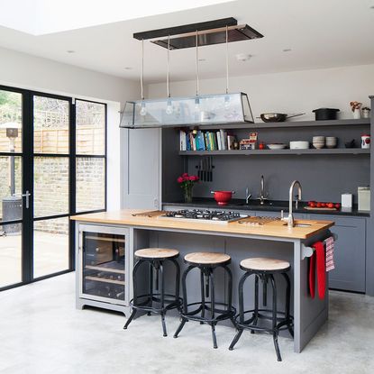 kitchen area with grey units and concrete floor