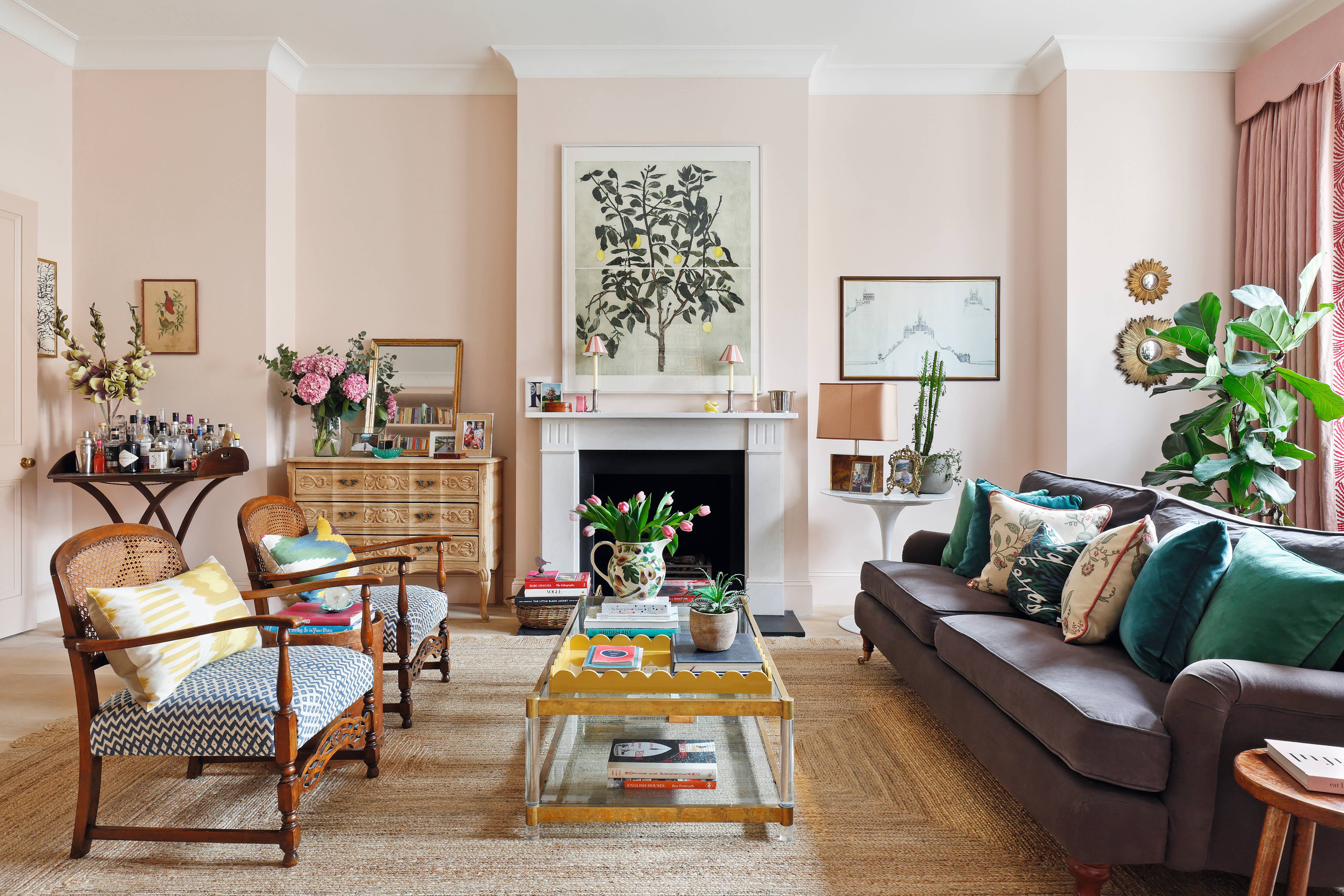 Pale pink living room with fireplace and grey couch