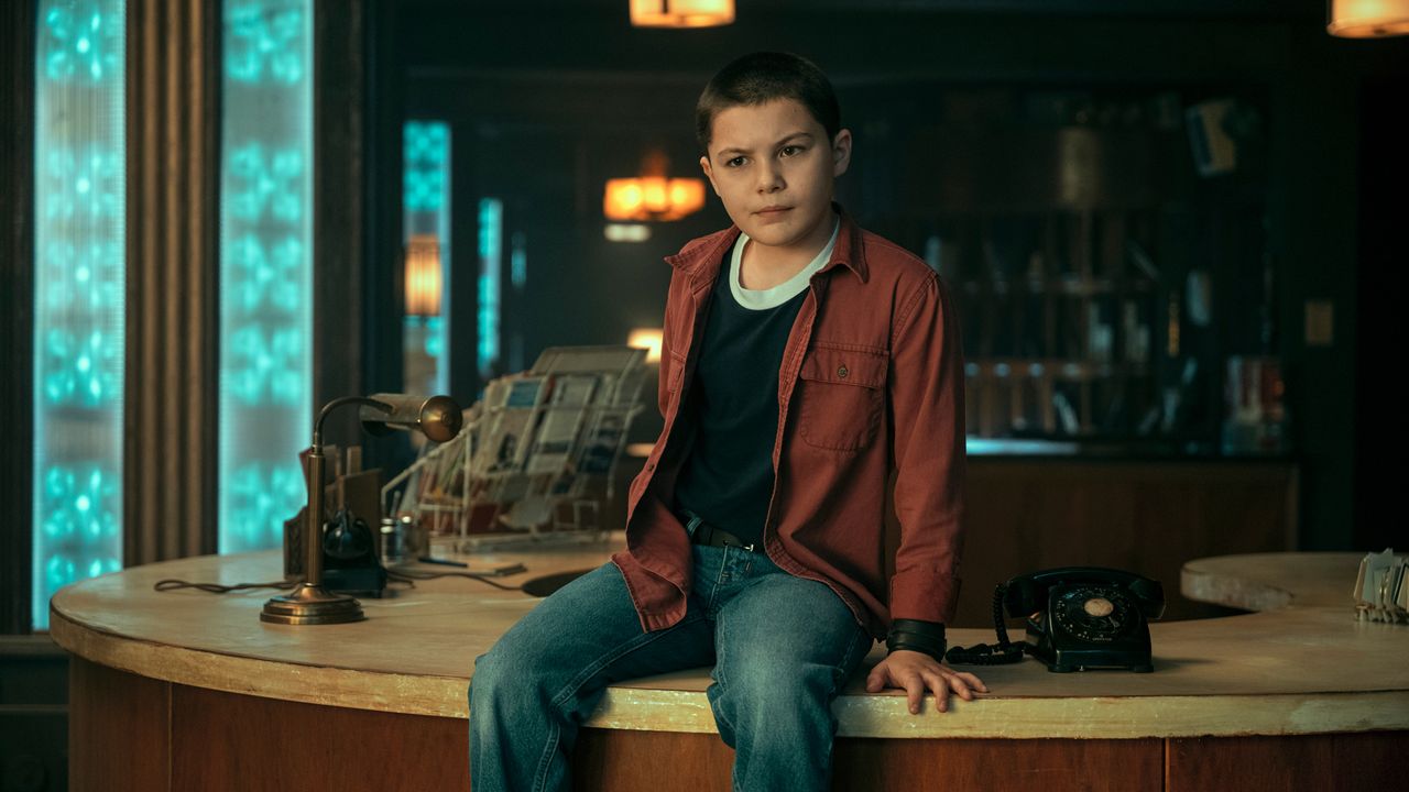 Euphoria actor Javon Walton sits on a desk in The Umbrella Academy season 3