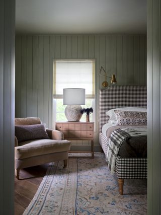 A bedroom with green walls and gray ceiling