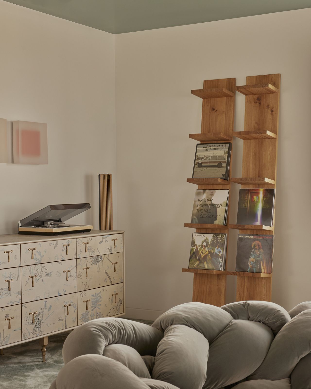 modern living room with record display shelves, a console with record player on it and edra boa sofa in foreground