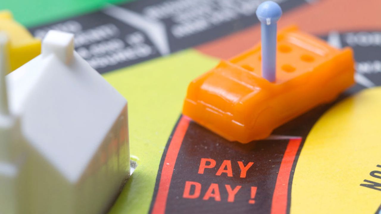 A board game with a toy car reaching the &amp;quot;Pay Day&amp;quot; spot.