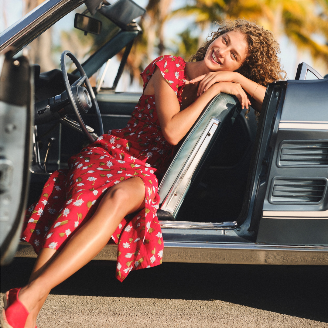 J.crew model wearing the palermo dress in ramie while sitting in a car 