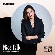 reshma saujani poses in a black blazer and smiles with mention of her appearance on the nice talk podcast