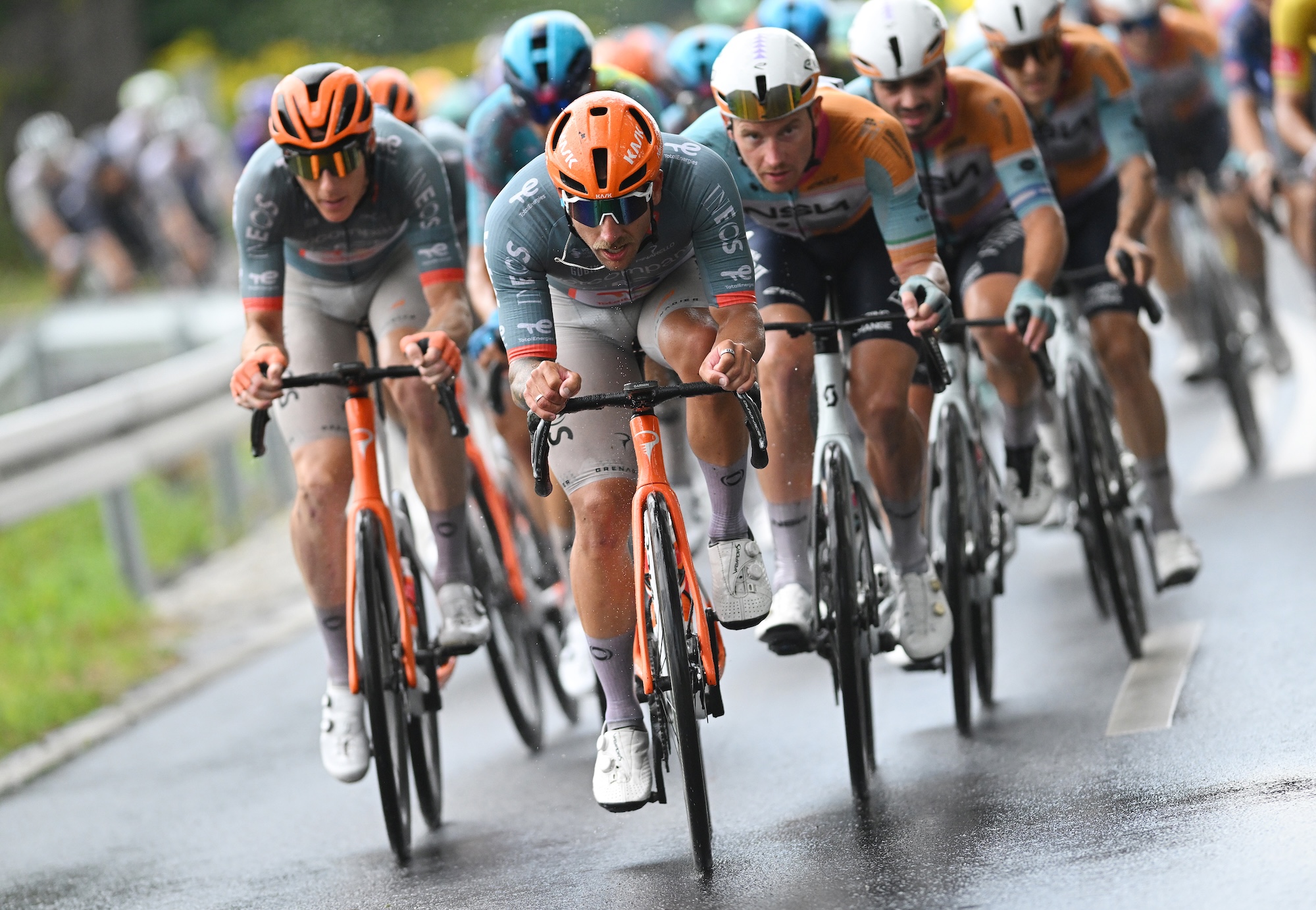 Netcompany-Ineos drive the chase on wet Polish roads, the kind of conditions where race design matters more than another component rule.