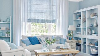 blue living room with white sofa and striped blind