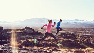 Man and woman trail running wearing tights