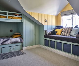 bedroom with built in bunk beds and window seats with panelled wall and a blue and yellow room scheme