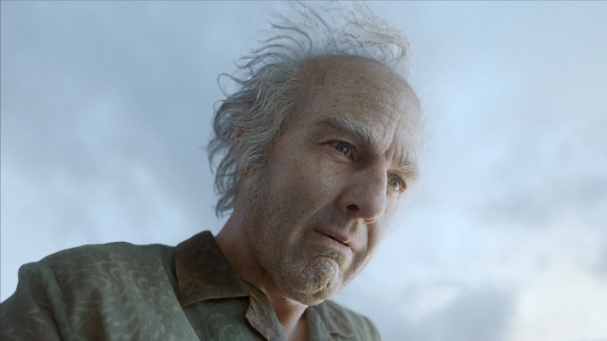Tom Cruise in a green suit and made up in old makeup and prosthetics in Digger (2026).