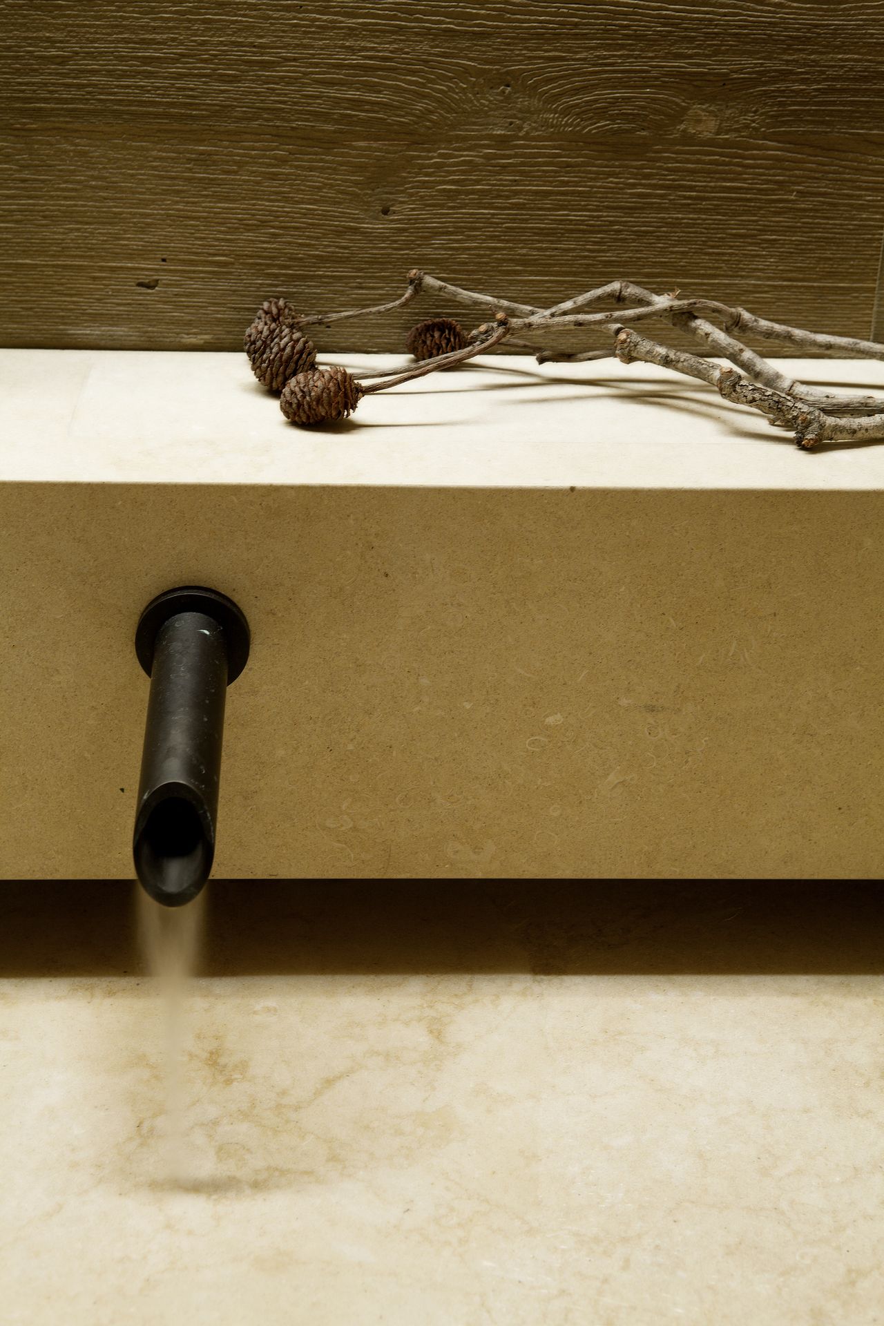A bathroom faucet shaped like a spout