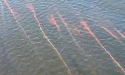 Streaks of oil can be seen in the Gulf of Mexico as a new spill makes its way onto Louisiana's sandy beaches.